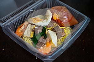 Mee Bandung Muar in a take out box, a Malaysia delicacy noodle originated from Muar District, Johore, Malaysia. The Noodle is a