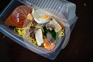 Mee Bandung Muar in a take out box, a Malaysia delicacy noodle originated from Muar District, Johore, Malaysia. The Noodle is a