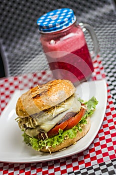 Burger with cheese tomato and a drink photo