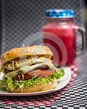 Burger with cheese tomato and a drink photo