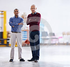 Meet the inspectors. Portrait of two factory managers doing a warehouse inspection.