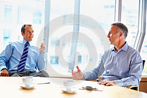 Meeting, conference room and business men in office for management conversation, talking and planning. Corporate workers