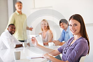 Meeting with her coworkers. Businesspeople listening to a presentation.