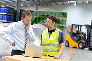 Meeting of the manager and worker in the warehouse - forklift an