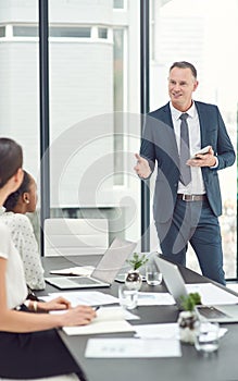 Meeting, mature man or ceo with business people in office for company update, task or conversation. Corporate strategy