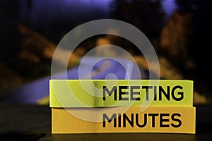 Meeting Minutes on the sticky notes with bokeh background