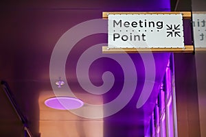 Meeting point sign at the tourist in a modern hall ,Meeting place for lost people or a safe point in an emergency