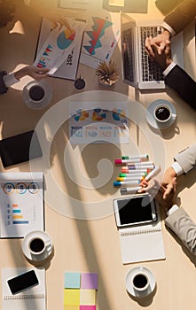 A meeting room full of information on the conference table