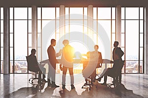 Meeting room. Group of businessmen around a table discussing work issues.