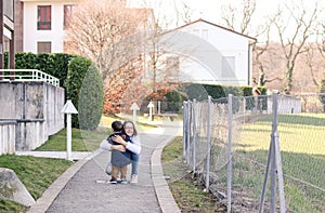 Meeting of sister and brother. Happy tween girl hugging her little brother happy to see him.