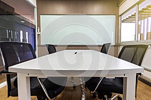 Meeting table and black chairs in meeting room