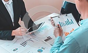 Meeting a team of businessmen, Executives and accountants meeting about the company`s revenue graph in the office with laptops an