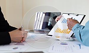 Meeting a team of businessmen, Executives and accountants meeting about the company`s revenue graph in the office with laptops an