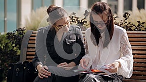 The meeting of two business women near business center. Meeting and discussion of the transaction two business women