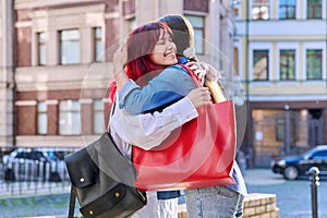 Meeting of two teenage girls friends, outdoor on the city street