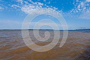 Meeting of Waters. Brazilian rivers confluence from Manaus photo