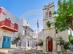 Megali Panagia or Metropolitan Greek Orthodox church of Mykonos, Cyclades, Greece in Alefkandra square. Greek flag