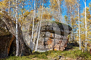 The megalith in autumn birch forests in Great Khingan