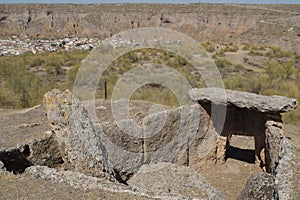 Megalithic dolmen with Gorafe village at background, Granada, Spain