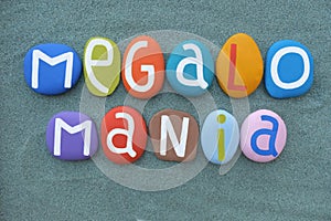 Megalomania, subtype of delusion, creative text composed with multi colored stone letters