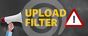 Megaphone or bullhorn against blackboard with text UPLOAD FILTER and warning sign