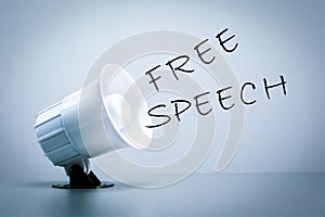 Megaphone with FREE SPEECH text on grey background.