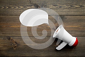 Megaphone make an announcement on dark wooden background top view copy space mockup