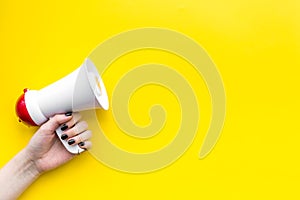 Megaphone make an announcement on yellow background top view copy space