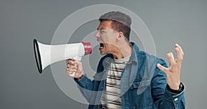 Megaphone, noise and shouting man in studio for broadcast announcement, news or info on grey background. Microphone