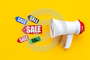 Megaphone with sale tags. Sales announcement concept