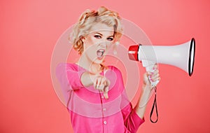 Megaphone and women. Portrait of pinup girl shouting. Young excited blonde woman screaming hot news, shouting in