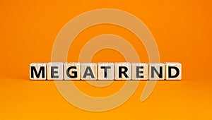 Megatrend symbol. The concept word Megatrend on wooden cubes. Beautiful orange table, orange background. Business and megatrend