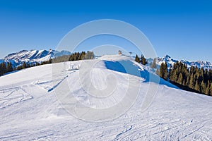 A Megeve ski slope in the middle of the mountains of the Mont Blanc massif in Europe, France, Rhone Alpes, Savoie, Alps, in winter