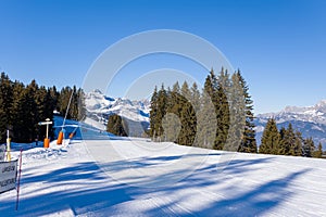 A Megeve ski slope in the middle of the mountains of the Mont Blanc massif in Europe, France, Rhone Alpes, Savoie, Alps, in winter