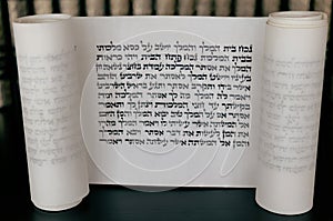 Megillat Esther (Book of Esther)  scroll on black backround and talmud.