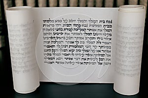 Megillat Esther (Book of Esther)  scroll on black backround and talmud. photo