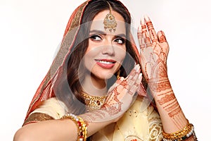 Mehendi. Portrait of beautiful indian girl in saree. Happy hindu woman model with kundan golden jewelry set. Traditional Indian