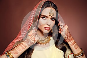 Mehendi. Portrait of beautiful indian girl in saree. Young hindu woman model with kundan golden jewelry set. Traditional Indian