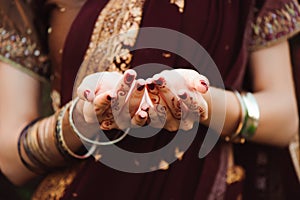 Mehndi covers hands of beautiful Indian woman