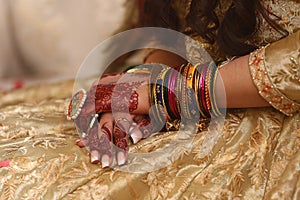 Mehndi Multi Colored bangles on the hands of the bride