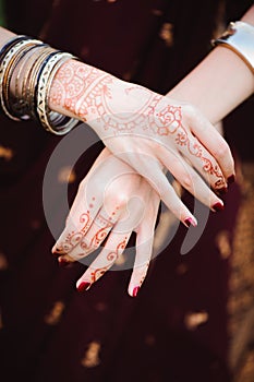 Mehndi tattoo. Woman Hands with black henna tattoos. India national traditions.
