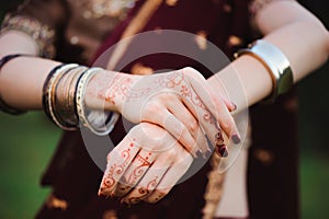 Mehndi tattoo. Woman Hands with black henna tattoos. India national traditions.