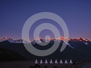 Meili snow mountain at sunrise with white pagodas, yunnan, china