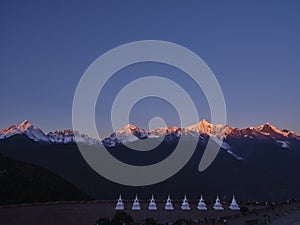 Meili snow mountain at sunrise with white pagodas, yunnan, china