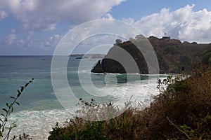 Meio beach in Brazil with a rocky shore on a bright sunny day photo