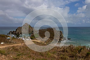 Meio beach in Brazil with a rocky shore on a bright sunny day photo