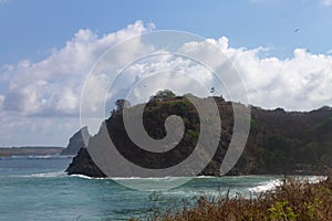 Meio beach in Brazil with a rocky shore on a bright sunny day photo