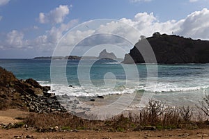 Meio beach in Brazil with a rocky shore on a bright sunny day photo