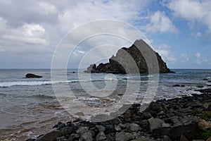 Meio beach in Brazil with a rocky shore on a bright sunny day photo