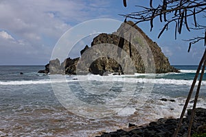 Meio beach in Brazil with a rocky shore on a bright sunny day photo